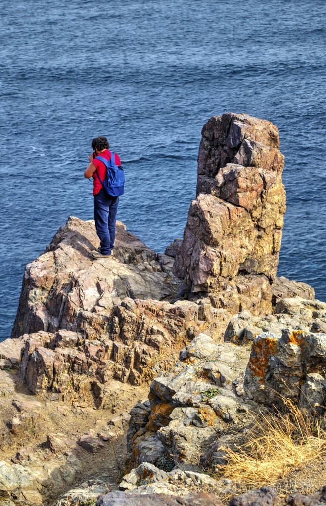 美丽的风景与游客拍照在岩石岸边