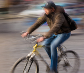 在城市道路上骑自行车的人图片