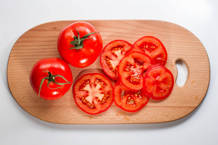 切丁案板在白色背景上的案板上的全切片新鲜西红柿照片