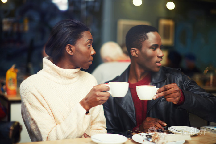 两个年轻的朋友拿着杯子喝咖啡朋友喝咖啡