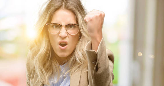 年轻美丽的女人恼怒和愤怒表达消极情绪, 恼怒与某人照片