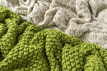 羊毛毛毯, 白色和绿色, 针织大矮胖纱。白色背景针织毛毯特写