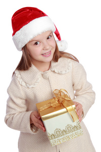 美丽微笑的小女孩，在圣诞老人的红帽子捧着圣诞的盒子