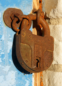 木门上的旧生锈的封闭挂锁