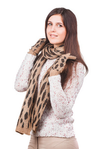 一个年轻女孩在白色的毛衣 围巾和手套的肖像