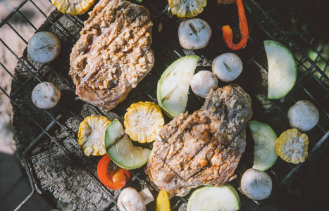 在烧烤的特写上煮肉。Champignons 和玉米在木炭上煮熟