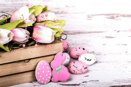 复活节姜饼饼干和木桌上美丽的郁金香花束。兔子和鸡蛋。贺卡。复制空间