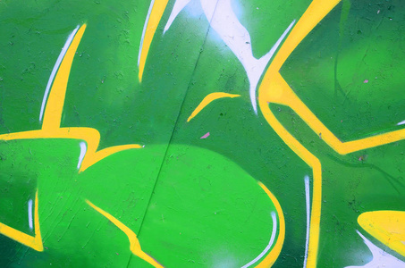 涂鸦画碎片。在街头艺术文化的风格上装饰着漆渍的旧墙。彩色背景纹理
