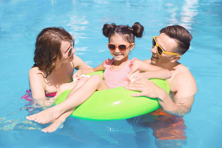 快乐的家庭在游泳池在度假胜地