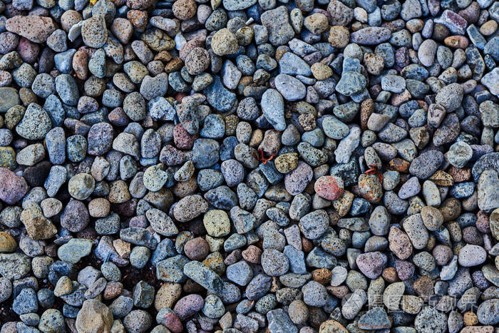 深色纹理卵石特写。在岸边的鹅卵石。天然鹅卵石背景