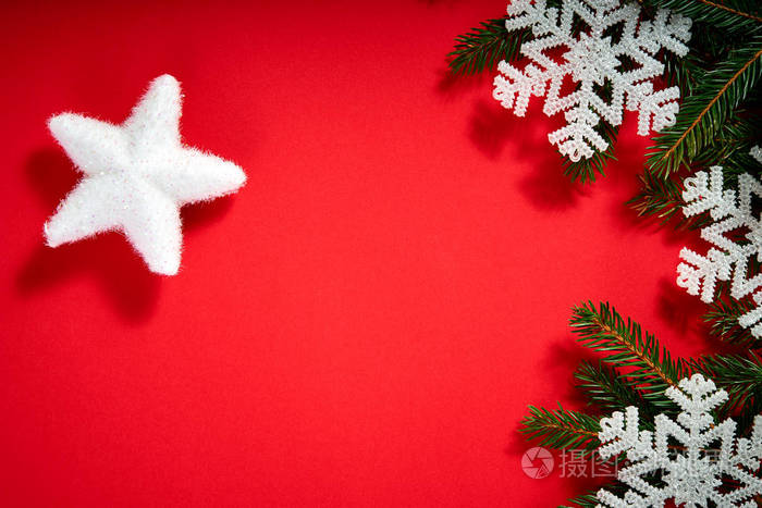 美丽的圣诞节白色的星星在红色背景与云杉树枝