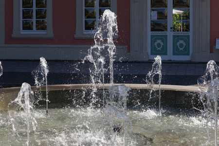 在6月的一个非常阳光明媚的一天, 在德国南部, 你看到在一个历史建筑前面的喷泉明亮的水珍珠