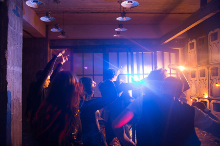 昏暗的夜总会内部 男女在一起庆祝新年的同时, 随着时尚的音乐跳舞的剪影