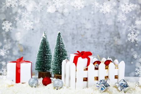圣诞节礼物和装饰品在一个白色的盒子上的雪在一个垃圾的背景。圣诞促销