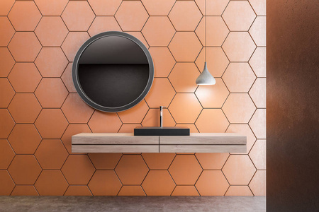 黑色浴室水槽站在木台面上的房间橙色蜂窝图案墙和圆形镜子。3d 渲染