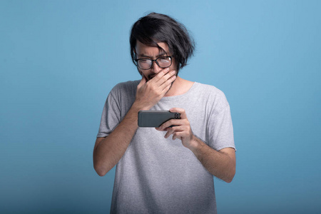 震撼亚洲年轻的时髦人玩手机游戏, 半身投篮.年轻一代时髦的概念照片