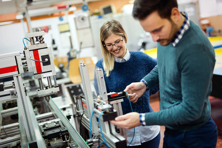 机电一体化项目的年轻有吸引力的学生一起工作照片