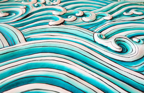 闭合的曲线下浮雕波浪混凝土雕塑背景纹理的闭合照片