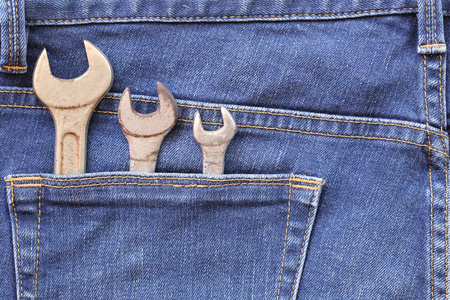 后袋蓝色牛仔裤和旧扳手工具与锈为设计在你的劳动节概念