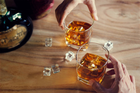 两个男人的特写杯威士忌喝酒精饮料一起在酒吧柜台在酒吧照片