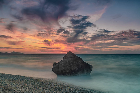 长曝光摄影在岩石加藤 Petres 海滩景观黄昏。希腊罗得岛