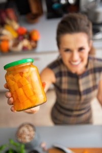 关于快乐的年轻家庭主妇显示 jar 的腌南瓜特写