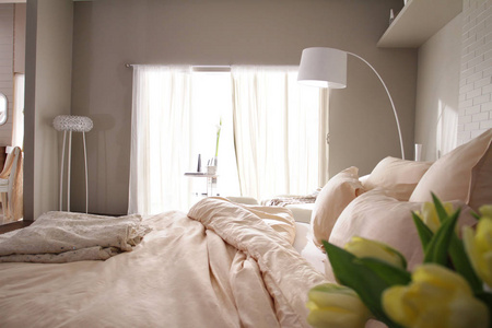 一个舒适的床在卧室醒来后, 从窗户美丽的光