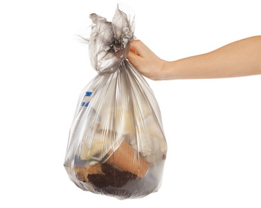 女人手拿着垃圾袋在白色背景上孤立照片