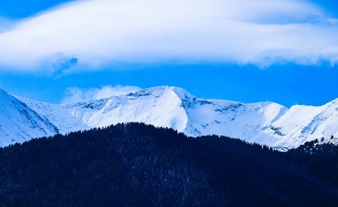 高山雪山, 美丽的自然冬日背景。山顶上的冰, 蓝天的背景。高山风景