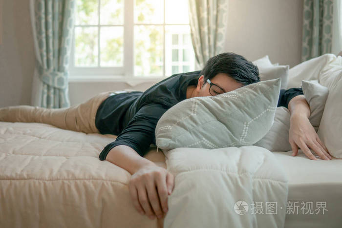 早上在卧室睡觉的年轻亚洲男人家居生活生活方式理念