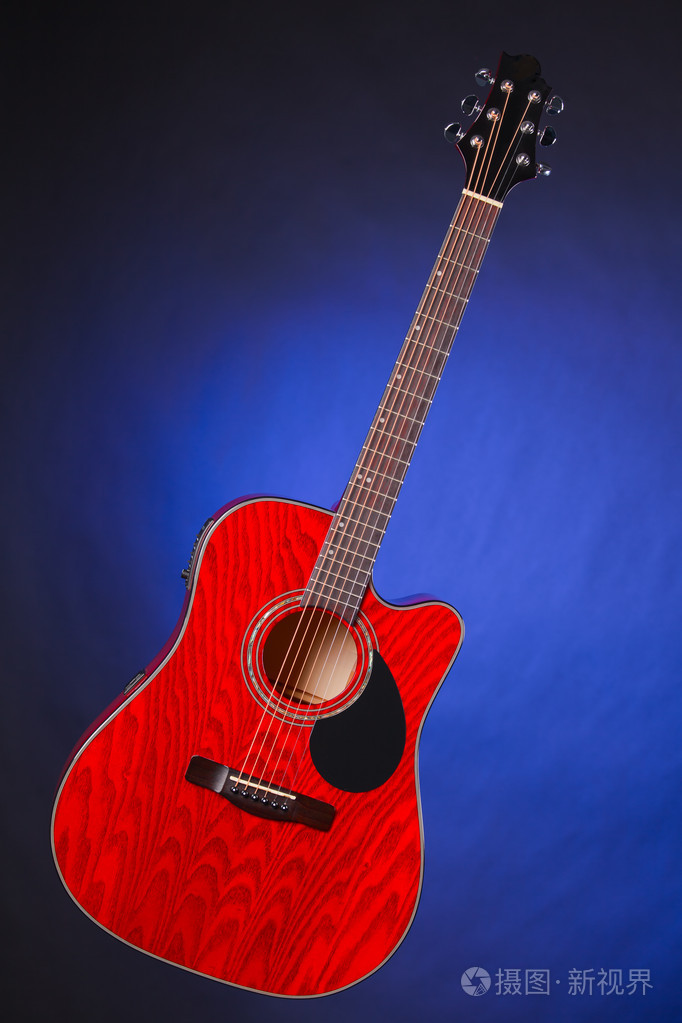 孤立在蓝色的原声吉他