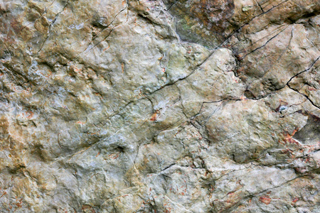 岩石的纹理和表面的背景。裂纹和风化的天然石背景