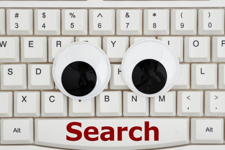 在互联网上搜索, 一个键盘的特写镜头, 一大组带有文字搜索的呆线眼睛