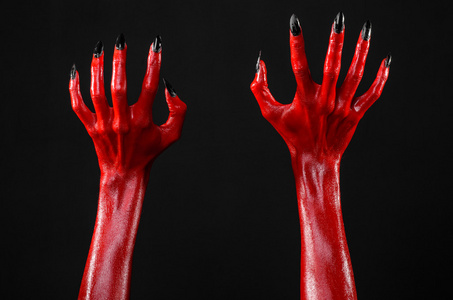 红魔鬼手,红色的手的撒旦,万圣节主题,黑色背景,孤立照片