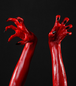 红魔鬼手,红色的手的撒旦,万圣节主题,黑色背景,孤立照片