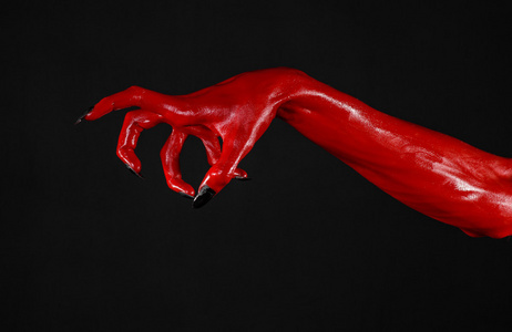 红魔鬼手,红色的手的撒旦,万圣节主题,黑色背景,孤立照片