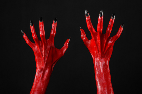 什么鬼红魔鬼手,红色的手的撒旦,万圣节主题,黑色背景,孤立照片