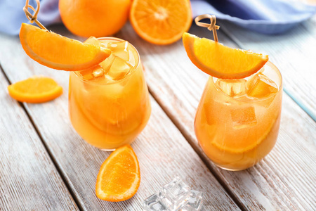 轻木桌上的美味橙鸡尾酒杯图片