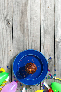 查看儿童生日表的概念。巧克力松饼烟火和装饰党在木质背景平躺