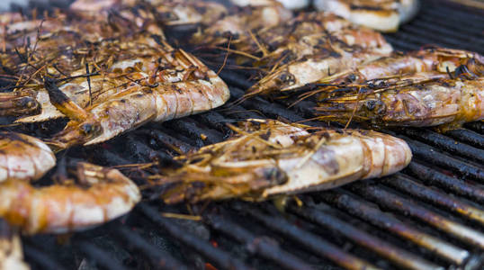 烹饪国王虾在美食节上的烤架上图片