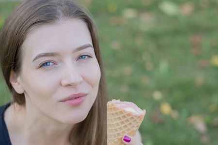 年轻快乐的女人吃冰激淋的肖像