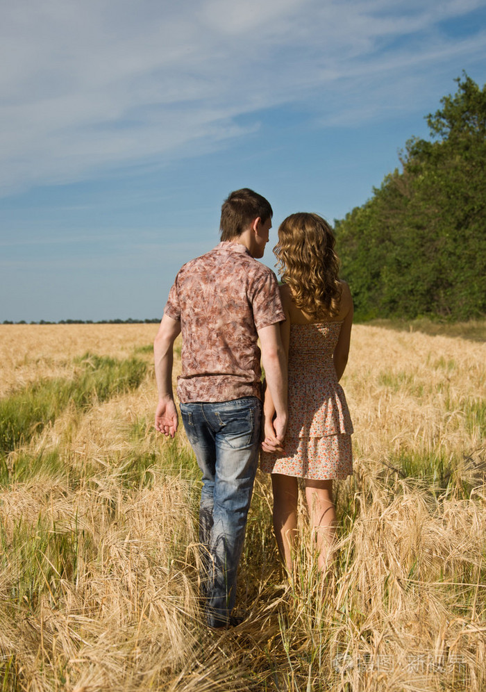 爱夫妇手挽手走在麦田