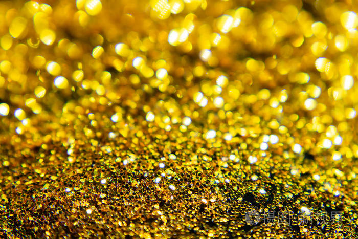 金色闪闪发光的闪光散景背景与光