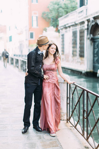 威尼斯蜜月期间沿着海滨散步的情侣摆姿势
