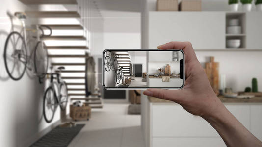 手持式智能手机, ar 应用程序, 模拟家具和室内设计产品在真正的家, 建筑师设计师的概念, 模糊的背景, 现代白色厨房