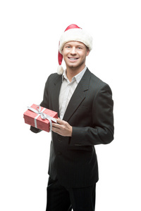 性格开朗的商人持有红色礼物的圣诞老人帽子