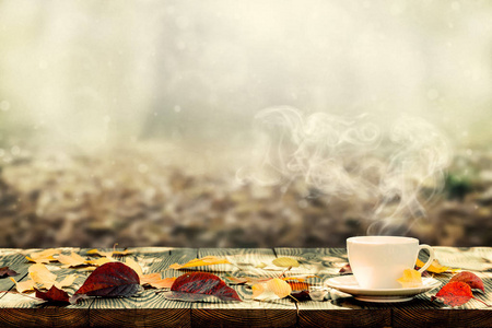 秋天背景的桌子上的热咖啡