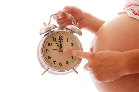 怀孕的女人控股时钟