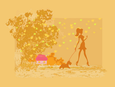 与她的狗在秋季景观步行的女孩剪影