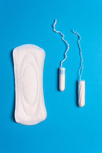 妇女卫生用品, 垫, 卫生棉条在蓝色背景。关键天, 月经周期, 月经的概念